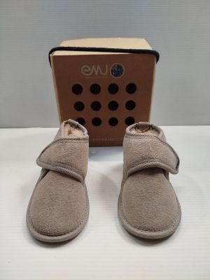 the baby ' s shoes are in front of a cardboard box