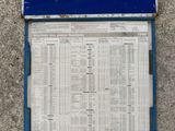 a blue sign on the side of a building that has a lot of information on it