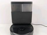 an image of a robotic vacuum cleaner on a white surface