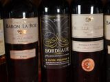 several bottles of wine are lined up on a shelf