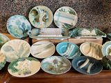 a lot of plates and bowls on the table