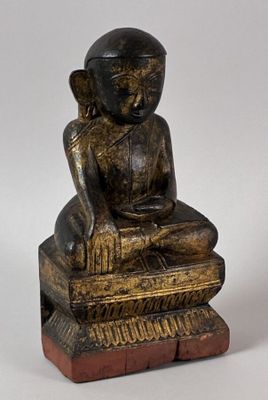 an image of a statue of a person sitting on a box