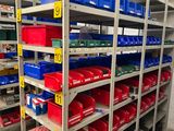 many bins and boxes on the shelves in the warehouse