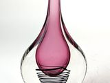 a pink glass vase with a spiral design on it