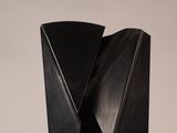 an image of a black sculpture on a white surface