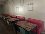 many tables and chairs lined up against the wall