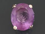 an image of a purple stone ring on a black surface