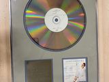 a picture of a cd in a frame on the wall