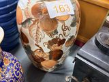 many vases that are on a table in a store
