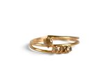 a close up of a gold ring with three stones on it