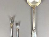 a spoon, fork, and spoon rest on a table