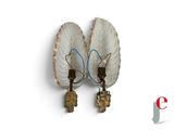 two lamps that are attached to a wall