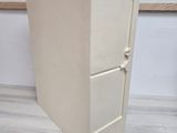 a white refrigerator sitting on a wooden floor next to a wall
