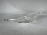 a glass bird shaped object on a white surface
