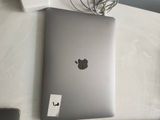 an apple laptop sitting on a table next to a mouse and keyboard