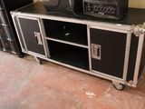 a black and silver entertainment center with speakers on top of it