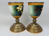 two vases that have been painted with flowers on them