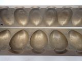 an image of a metal tray with five eggs in it