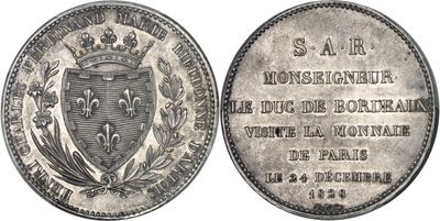 a close up of a coin with a coat of arms on it