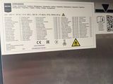 a picture of a stainless steel refrigerator with a sign on it