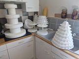 many stacks of cake sitting on the counter in the kitchen