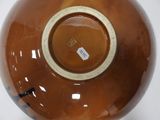a brown vase with a tag on it on a white surface
