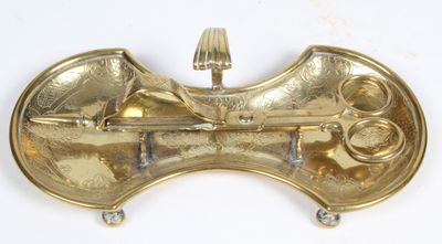 a gold metal object on a white surface