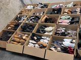 many pairs of shoes in boxes on the floor