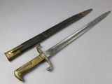 two knives are sitting next to each other on a white surface
