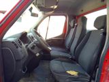a red van with black seats and a yellow sticker on the seat
