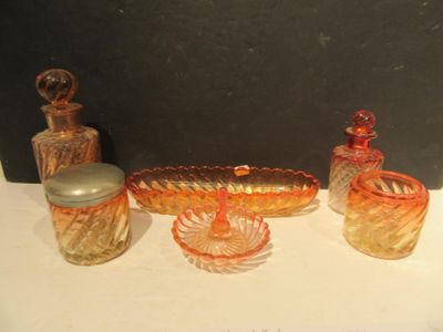 three different colored glass items sitting on a table