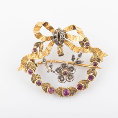 an image of a broochle with a bow and flowers on it