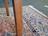 a cat that is sitting on a rug on the floor