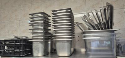 many pots and pans sitting on the kitchen counter