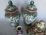 two vases and a small vase sitting next to each other