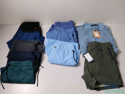 several pairs of men ' s pants are laid out on a table