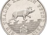 une image représentant une pièce d'argent sur laquelle figure un rhinocéros couché sur le dos