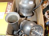 a box full of silver items on the floor
