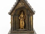 a statue of a woman holding a baby in a small building