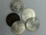 quatre types de pièces différents sont présentés sur une surface blanche
