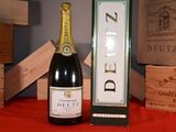 a bottle of wine sitting next to a box of wine