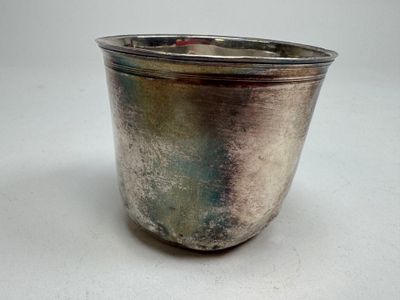 a silver cup that is sitting on a table
