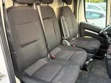 four seats in the back of a van that are empty