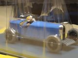 a blue toy car with a man in a blue car