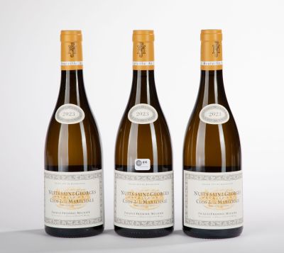 three bottles of wine sitting on top of a table next to each other