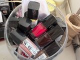 a glass bowl filled with makeup products on a table