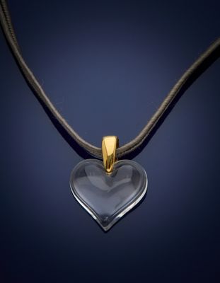 a heart shaped glass pendant on a black cord necklace
