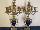 pair of antique brass candelabs with blue vases on stands