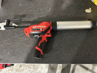 an electric tool sitting on top of a table next to other tools
