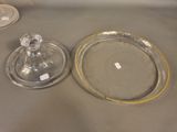two glass dishes on a table with a glass lid